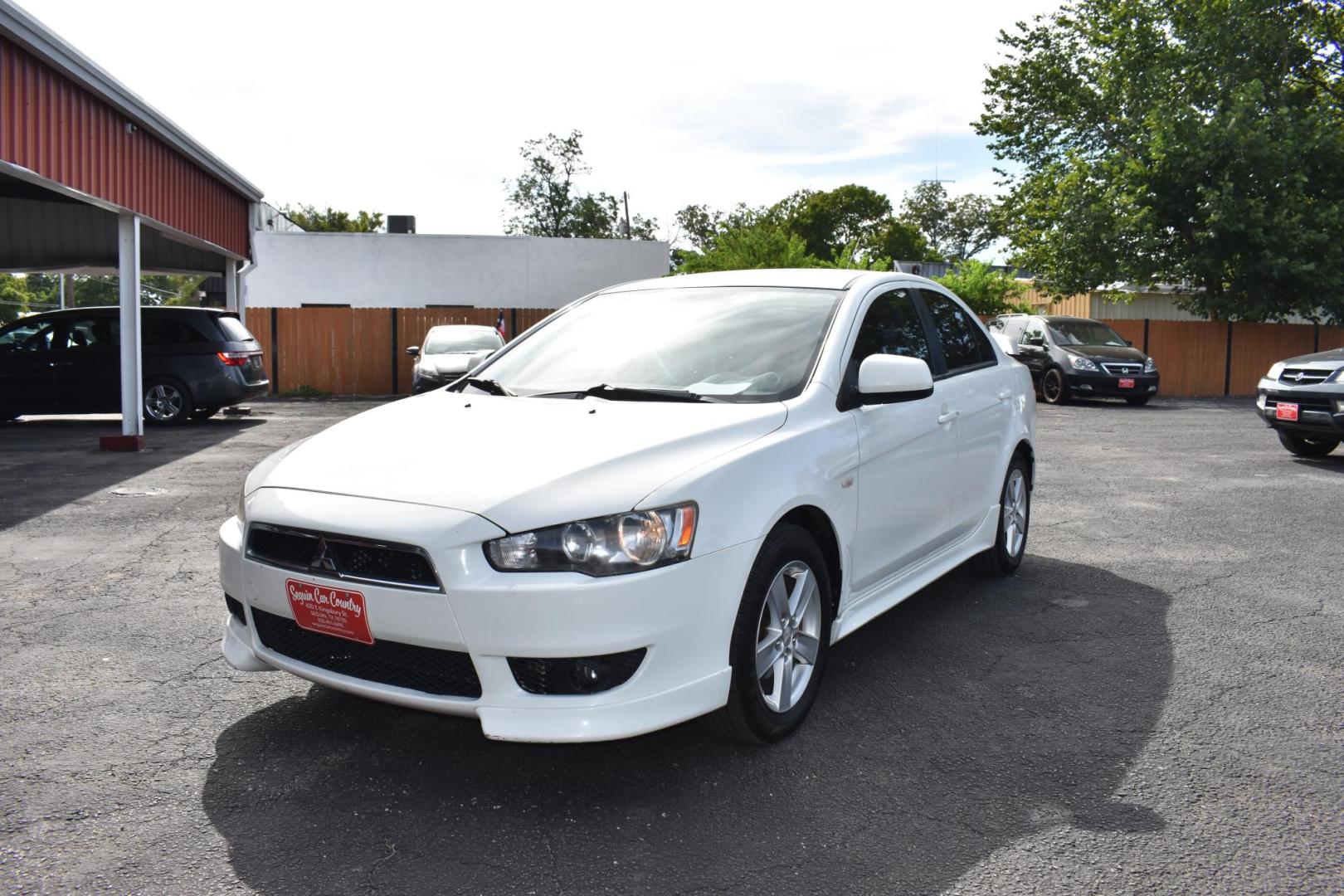 2009 WHITE /BLACK MITSUBISHI LANCER (JA3AU26U29U) with an 2.OL 4 CYLINDER engine, AUTOMATIC transmission, located at 420 E. Kingsbury St., Seguin, TX, 78155, (830) 401-0495, 29.581060, -97.961647 - Photo#1